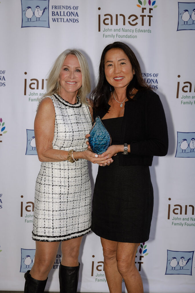Lucy and Jan receiving an award.